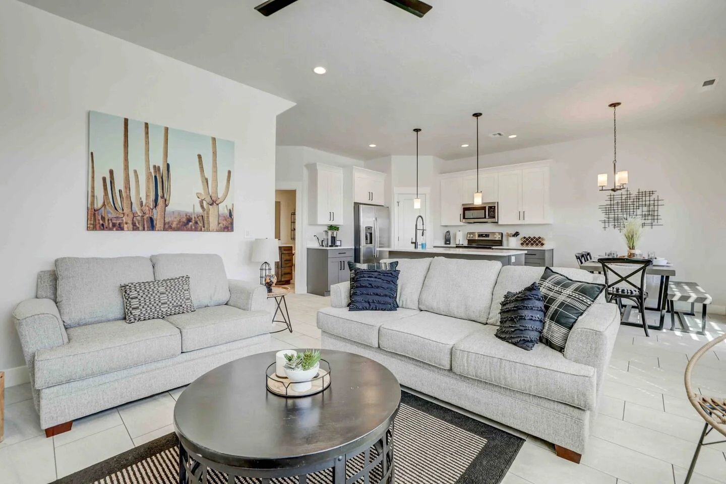 Open-plan living room and kitchen with a sofa, coffee table and island